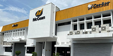 white building with mcgean logo blue sky background